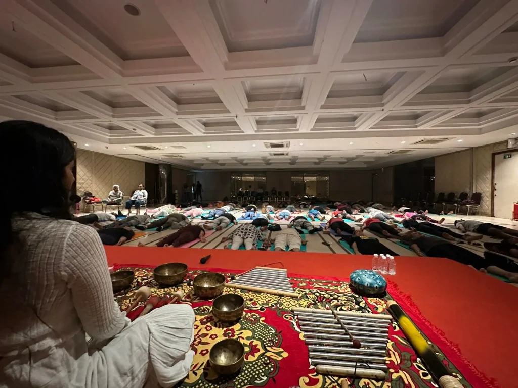 What Is Sound Healing? How It Works, Benefits & What the Evidence Says 4 Sound healing session with singing bowls laid out in the hall at Jeevatman Yogshala, Rishikesh